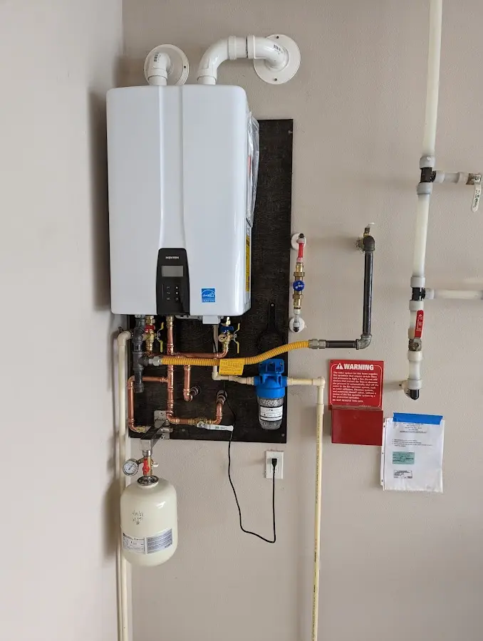 Professional plumber installing copper piping in a Millburn home